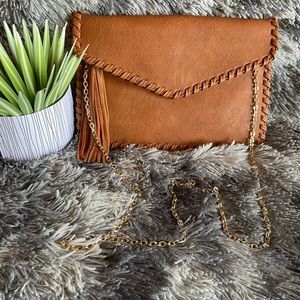 Moda Luxe leather crossbody bag with chain strap and tassel detail